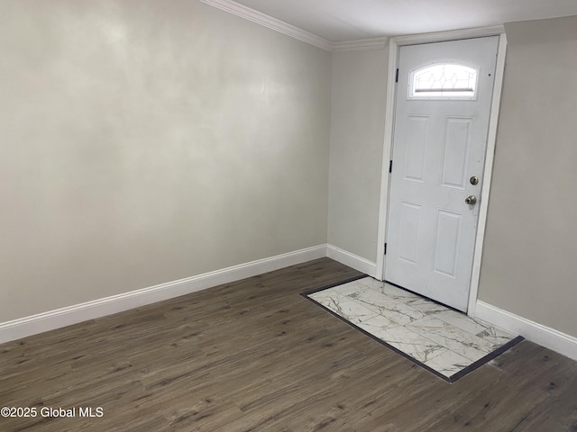 entrance foyer featuring crown molding, baseboards, and dark wood-style flooring