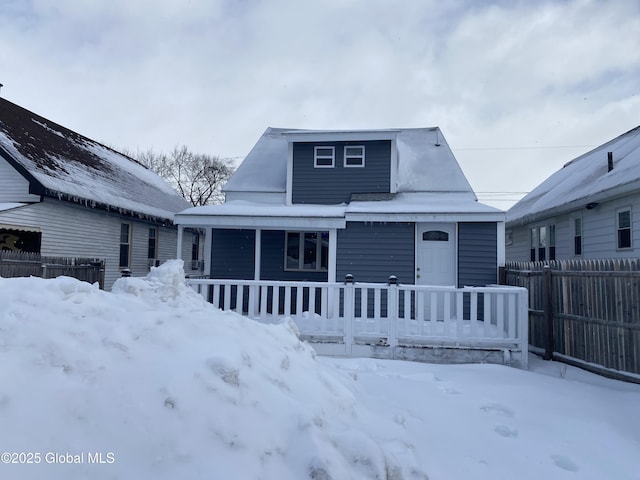 bungalow-style house with a porch and fence