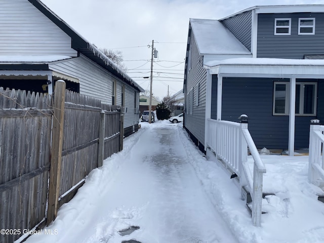 view of snowy exterior with fence