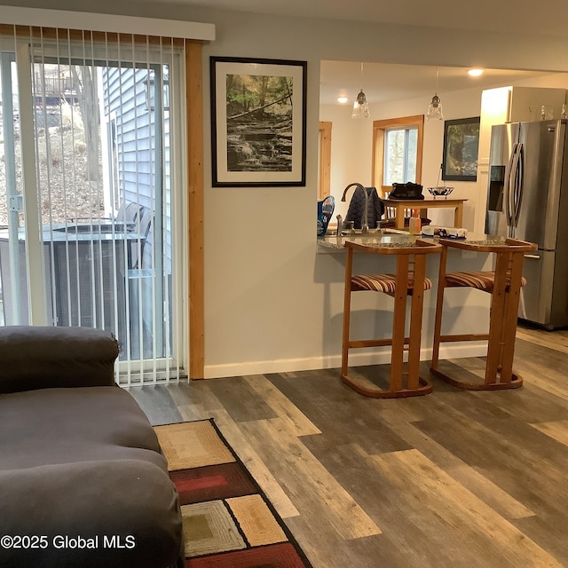 interior space with baseboards and wood finished floors