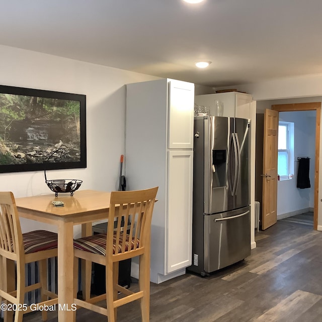 kitchen featuring dark wood-style floors, white cabinets, and stainless steel fridge