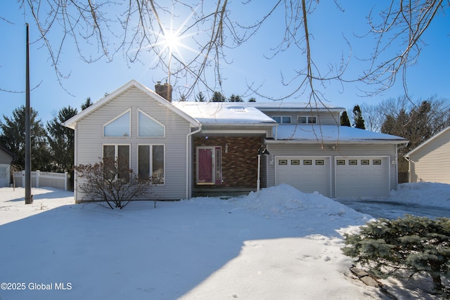 view of front of property with a garage, a chimney, and brick siding