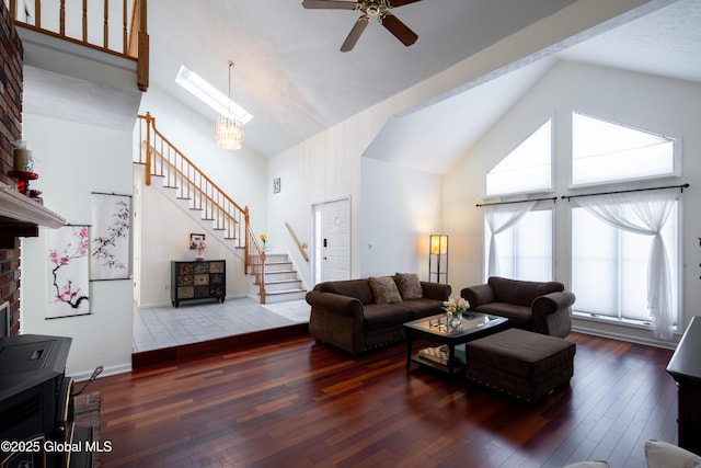 living area featuring high vaulted ceiling, dark wood-style flooring, baseboards, and stairs