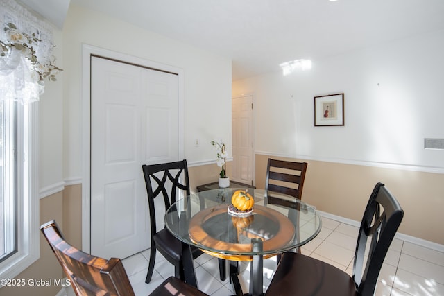 dining room with light tile patterned flooring and baseboards