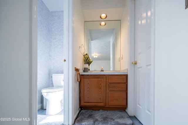 bathroom featuring toilet and vanity