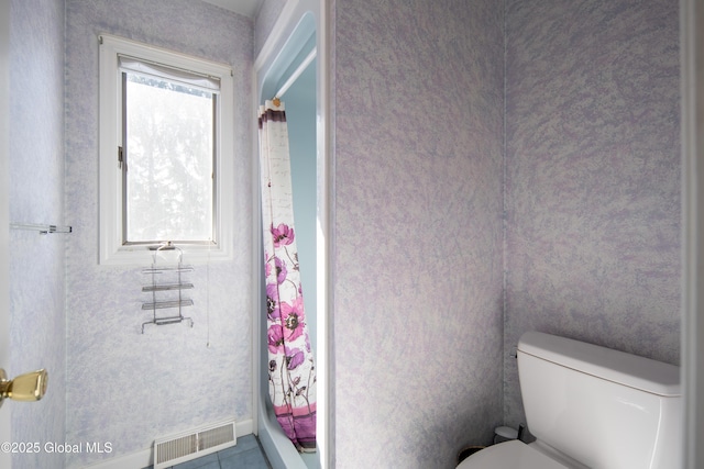 bathroom featuring toilet and visible vents