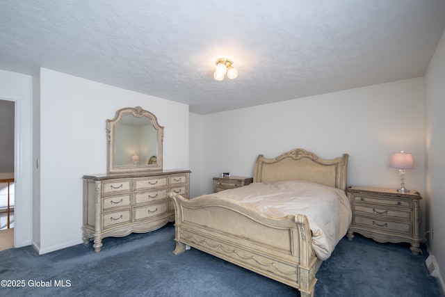 bedroom featuring dark colored carpet, a textured ceiling, and baseboards