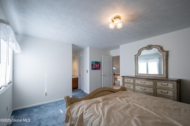 bedroom featuring carpet floors, baseboards, and a textured ceiling