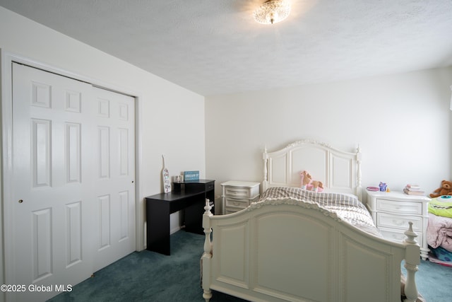 bedroom featuring a textured ceiling and dark carpet