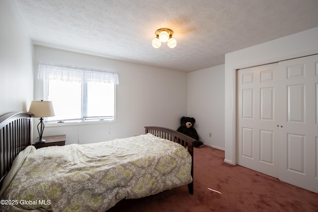 carpeted bedroom featuring a closet and a textured ceiling