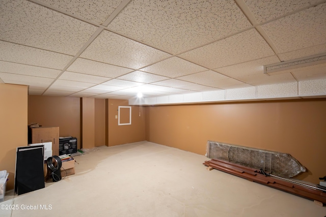 finished basement featuring a drop ceiling