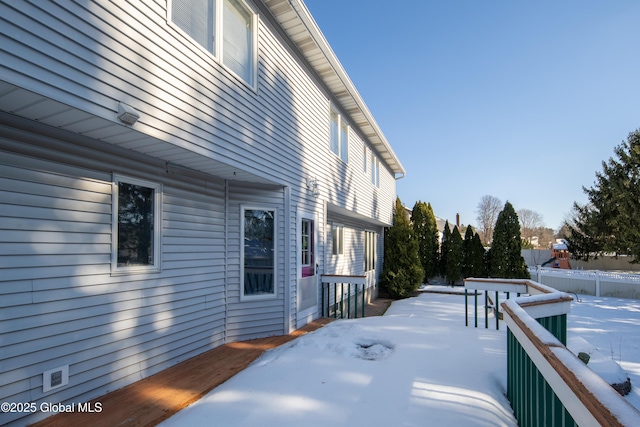 view of snowy exterior with a deck