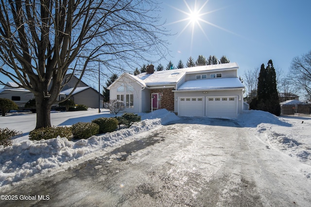 view of front of property with a garage, driveway, and a chimney