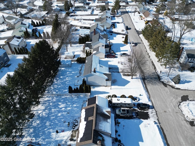 snowy aerial view featuring a residential view