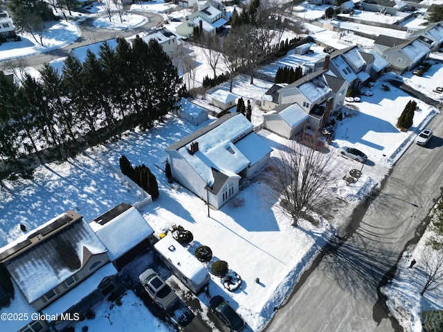 snowy aerial view with a residential view