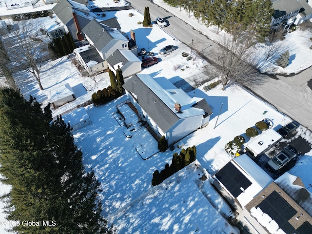 snowy aerial view with a residential view