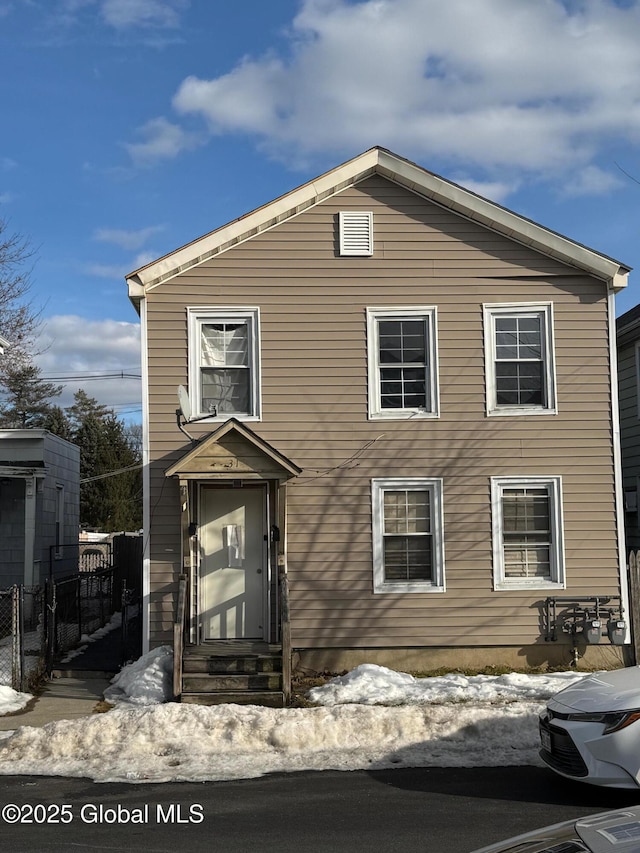 view of front facade featuring fence