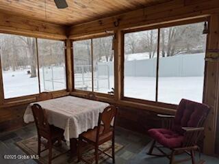 sunroom / solarium featuring wooden ceiling and ceiling fan