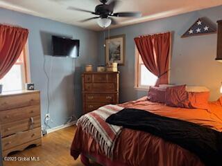 bedroom featuring ceiling fan and light wood-type flooring