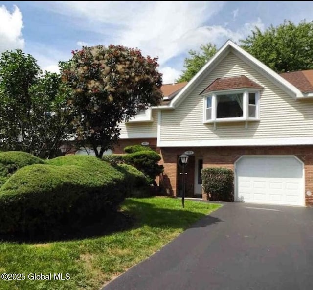 view of front of home featuring brick siding and an attached garage