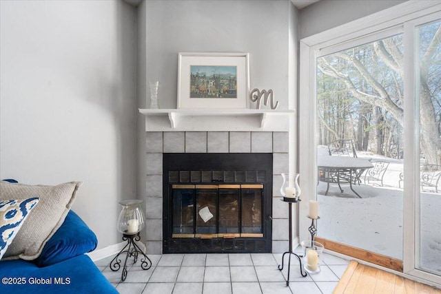 room details featuring baseboards and a tiled fireplace