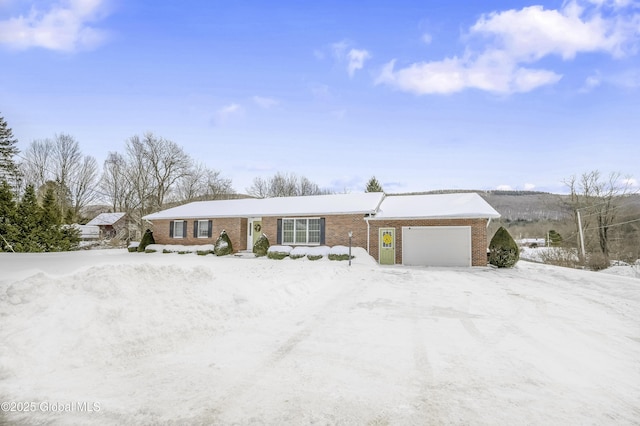 single story home with brick siding and an attached garage