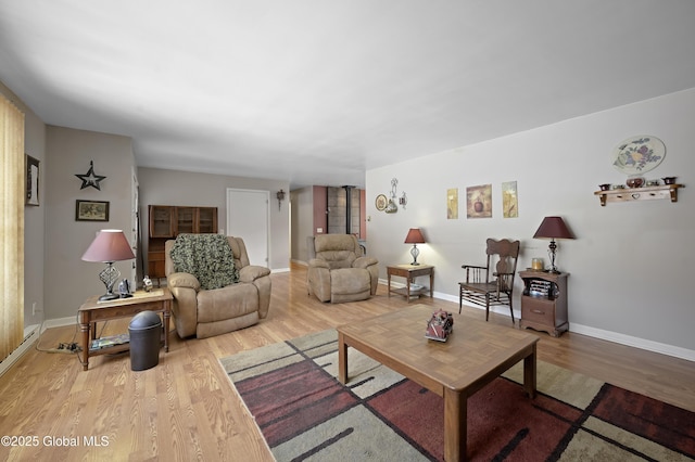 living area with baseboards and wood finished floors