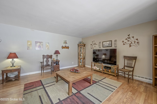 living area with baseboards and wood finished floors