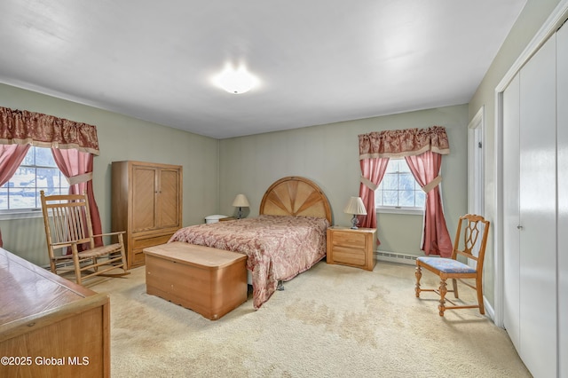 bedroom with a closet, a baseboard radiator, and carpet flooring