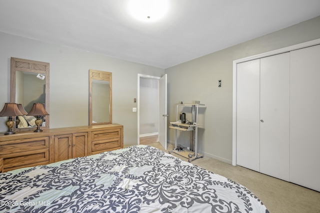 bedroom with carpet floors, baseboards, and a closet