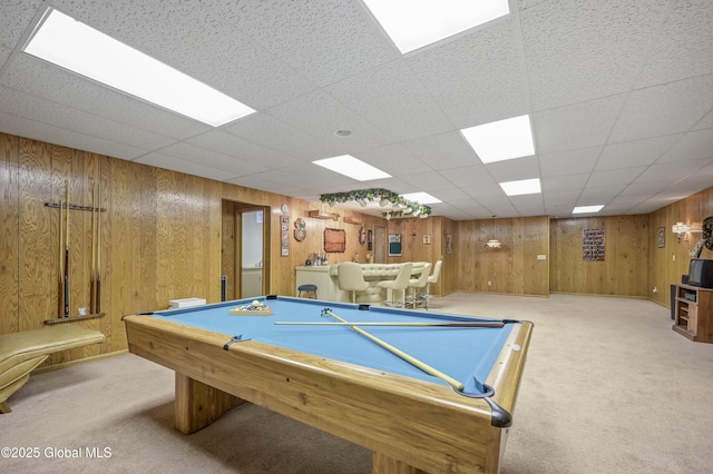 recreation room featuring carpet and wooden walls