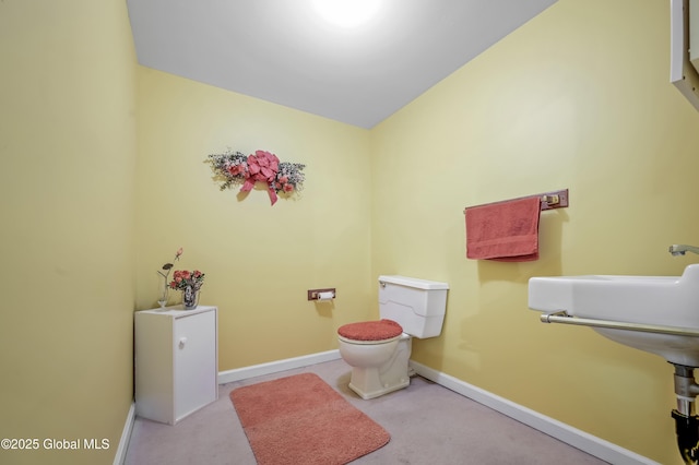 bathroom featuring toilet and baseboards