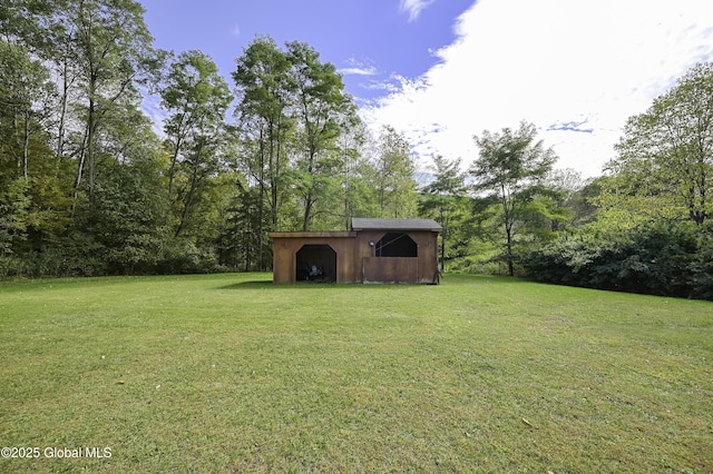 view of yard with an outbuilding and a shed