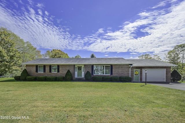 single story home featuring aphalt driveway, a front lawn, an attached garage, and brick siding