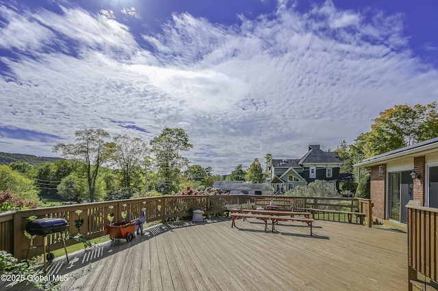 wooden terrace featuring grilling area