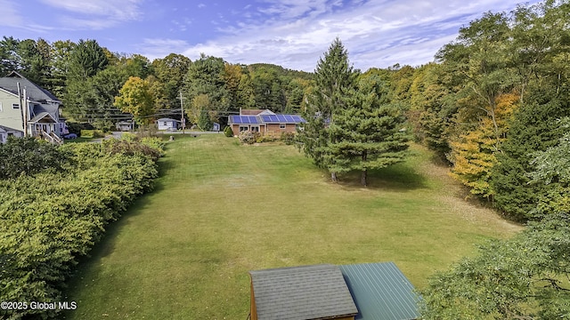 birds eye view of property with a forest view