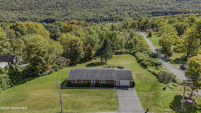 birds eye view of property with a view of trees