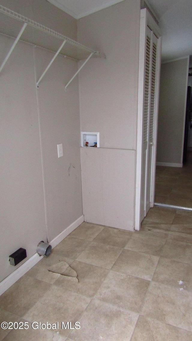 laundry room featuring laundry area, washer hookup, and baseboards