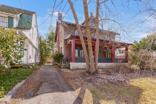 view of front of house with a porch and a chimney