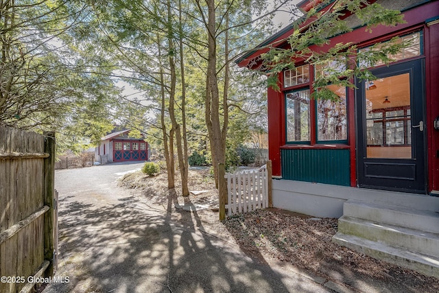 exterior space featuring driveway and fence