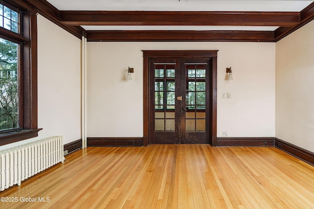 entrance to property featuring radiator and french doors