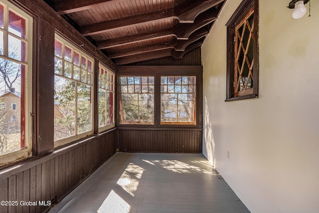 unfurnished sunroom with wood ceiling and vaulted ceiling with beams