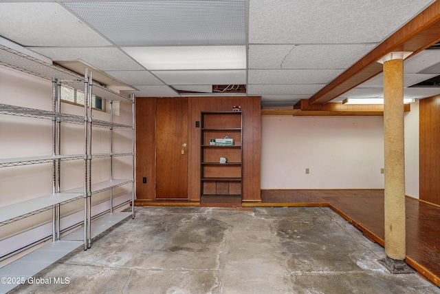 finished basement with a paneled ceiling