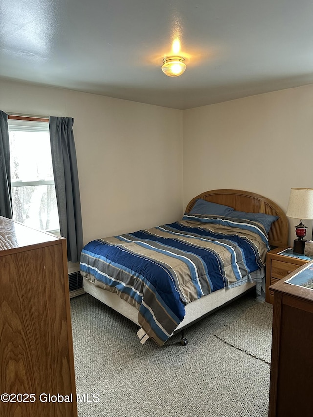 carpeted bedroom featuring visible vents