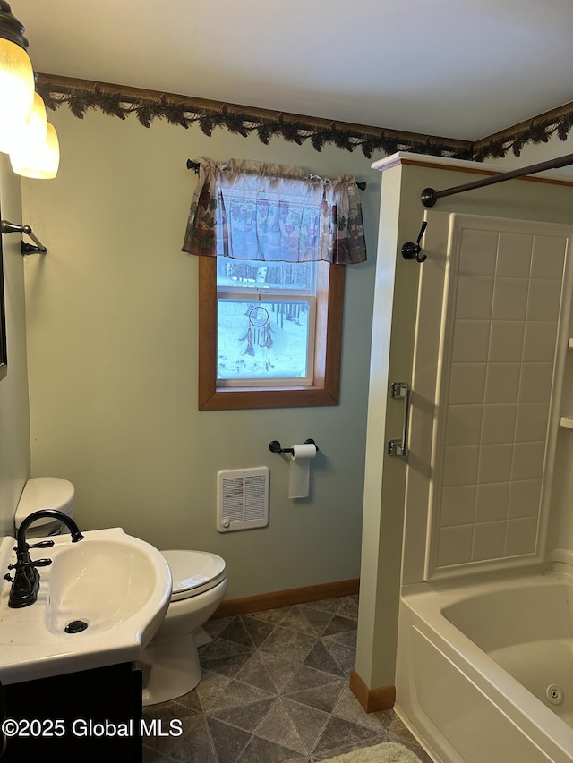 bathroom with toilet, tub / shower combination, vanity, and baseboards