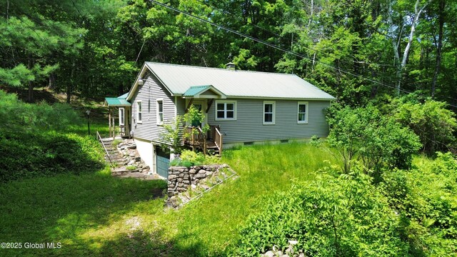 28 Hollow Rd, Hague, NY 12836 - back of house featuring metal roof, stairway, a view of trees, and an attached garage