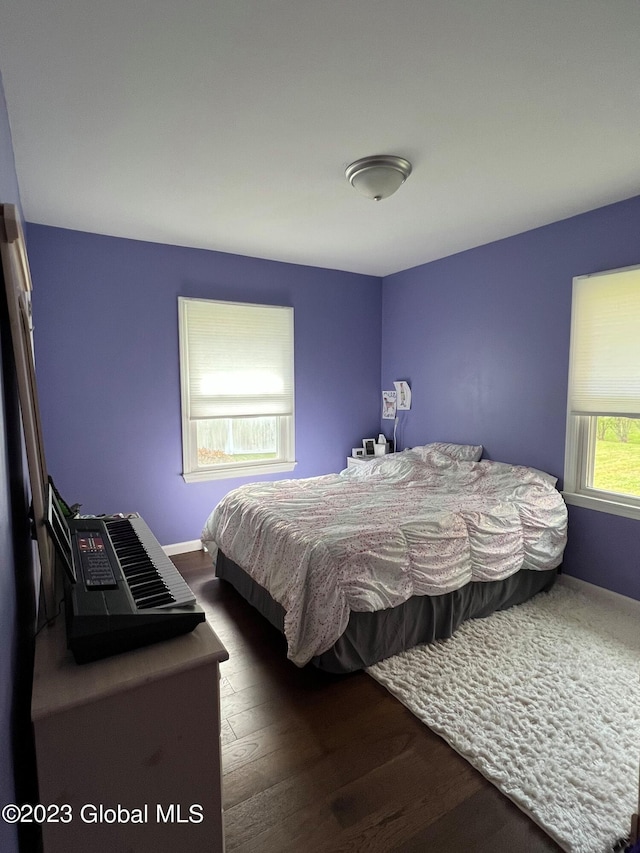 bedroom featuring wood finished floors and baseboards