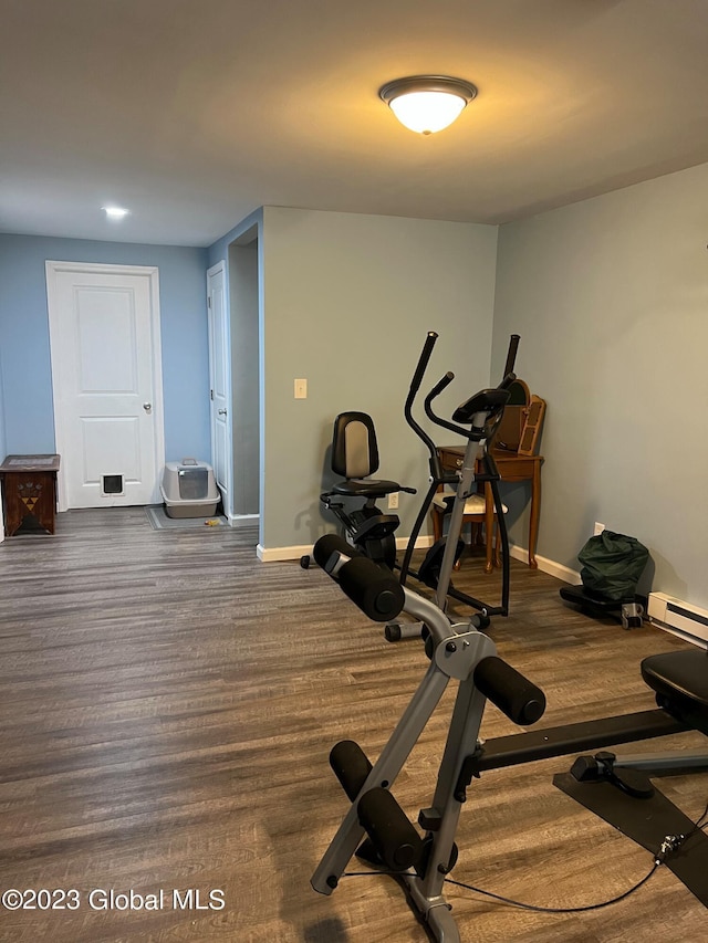 workout area with dark wood-style flooring and baseboards