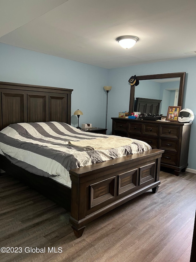 bedroom featuring visible vents and wood finished floors