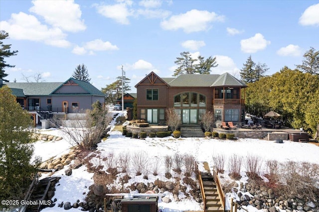 view of snow covered rear of property